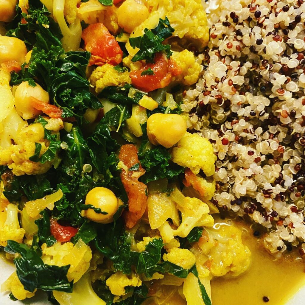 Cauliflower, Kale and Chickpea Curry served in a bowl.