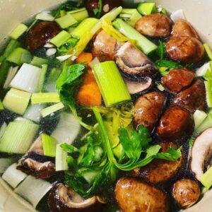 Diced veggies in a stock pot with broth.