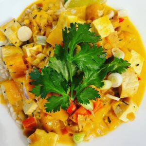 Punchy Peanut Curry in a bowl with parsley garnish on top.