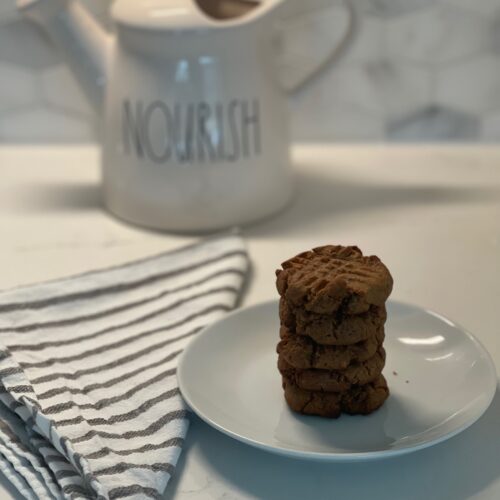 A stack of cookies on a plate.